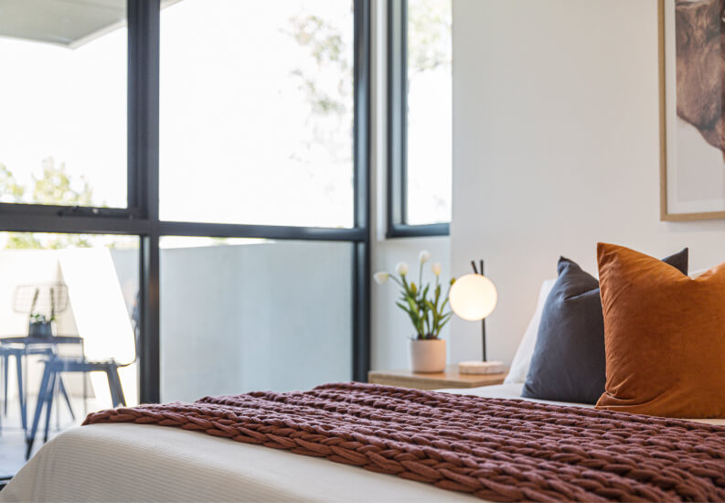 Bedroom With Large Windows and Textured Bedding at Independent Living Facility Bedroom With Large Windows and Textured Bedding at Independent Living Facility