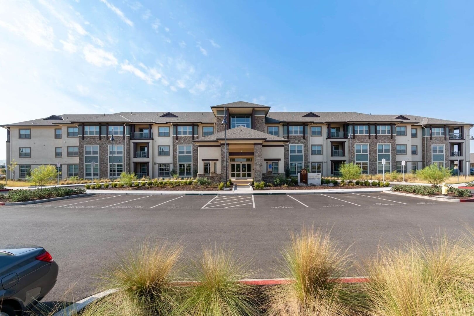 Modern Building Entrance with Landscaped Parking at Independent Living Facility