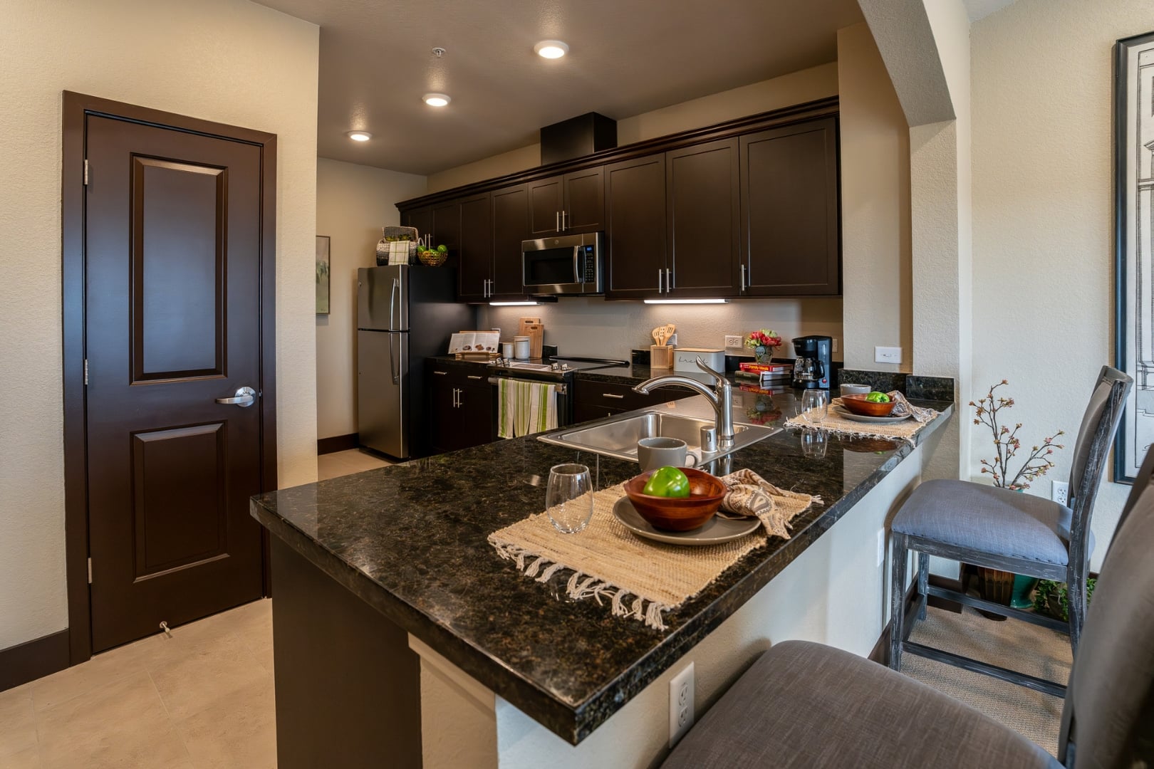 Kitchen with Granite Counters and Bar at Independent Living Facility