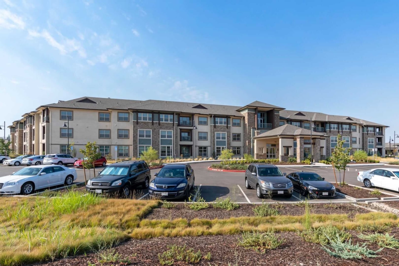 Resident Parking Area Beside Building Exterior at Independent Living Facility