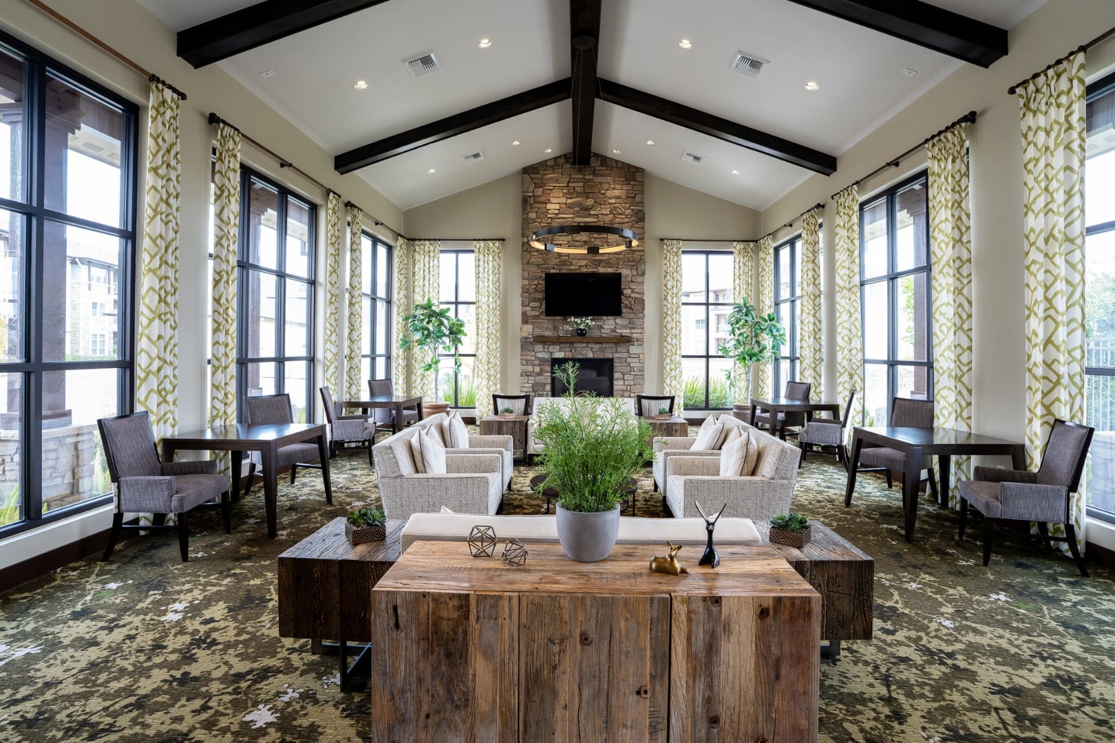 Vaulted Sunroom Lounge with Stone Fireplace at Independent Living Cottages