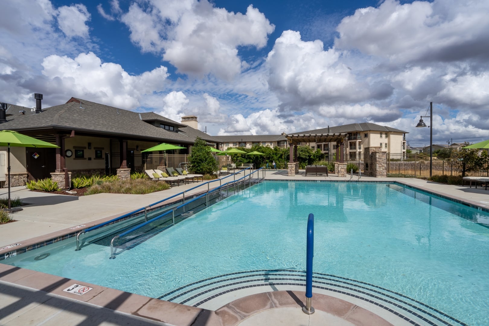 Poolside View with Clubhouse and Pergola at Independent Living Facility