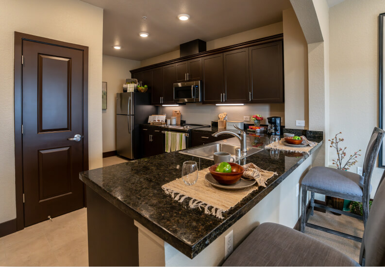 Kitchen with Granite Counters and Bar Seating at Independent Living Facility Kitchen with Granite Counters and Bar Seating at Independent Living Facility