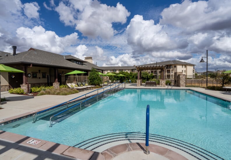 Resort Style Pool with Lounge Chairs at Independent Living Facility Resort Style Pool with Lounge Chairs at Independent Living Facility